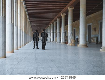 Athens, Greece - January 07,2015. Two men at long hall at the entrance of the Museum   Ancient Agora, Athens, Greece.
