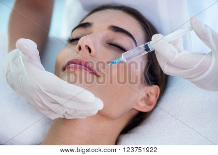 Woman receiving botox injection at spa