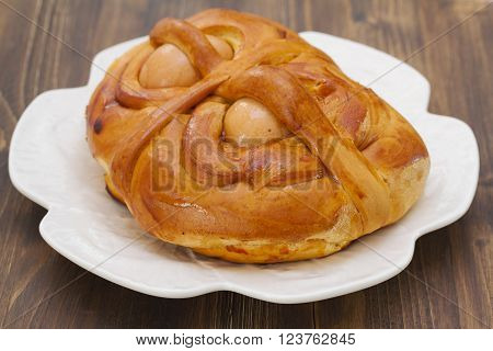 portuguese traditional Easter cake Folar on brown wooden background