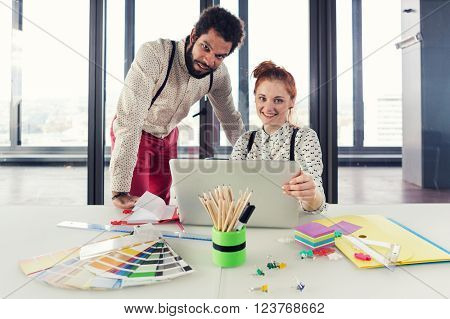 Business people in modern office posing for camera. Post processed with cross process filter.