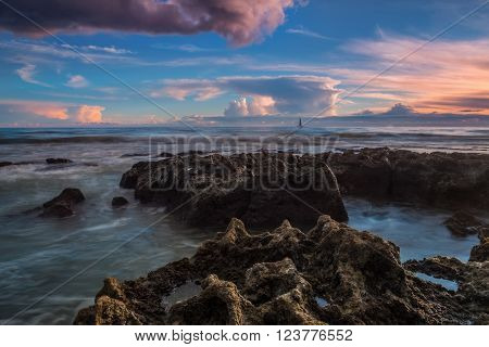 Dramatic seascape sailing ship in the distance. Gale Beach Albufeira.
