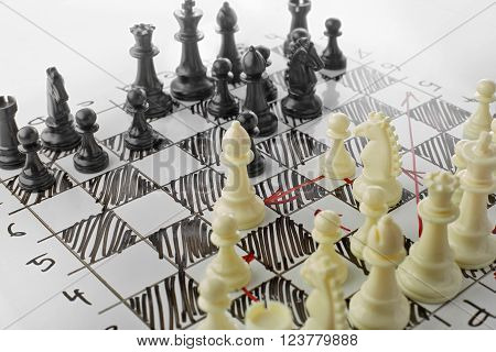Chess, white's attack. White board with chess figures on it. Plan of battle.