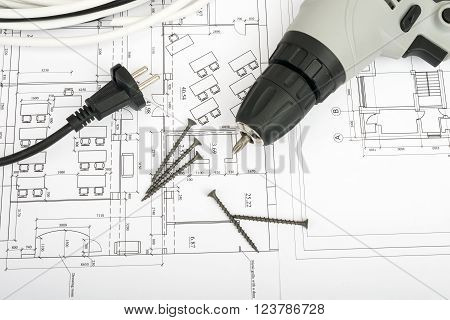 Architecture plan and rolls of blueprints with cabel and electric screwdriver. Building concept