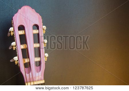 Music school for children with purple guitar closeup on blackboard background