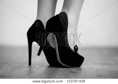 Autumn fashion outfit. Fashionable woman long legs in tights black stylish high heels shoes with rhinestones