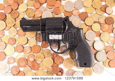 Picture of a Business Money Concept Idea Coins and Gun
