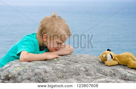 Cute little boy plays with soft toy staring game
** Note: Visible grain at 100%, best at smaller sizes