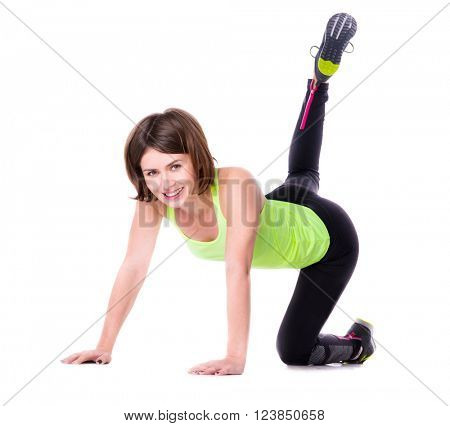 sport woman on her knees thowing back her leg