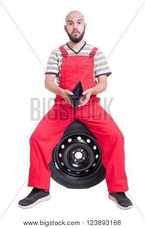 Broke mechanic showing his empty wallet isolated on white