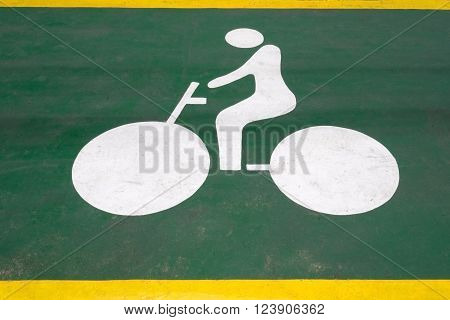 Bicycle symbol on green road for bicycle lane. Bicycle sign to indicate bike lane increasing traffic safety.