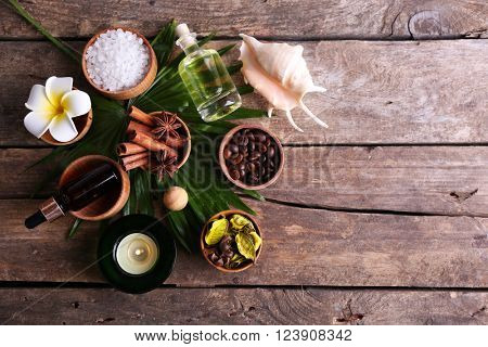 Beautiful spa setting on palm leaf on wooden table