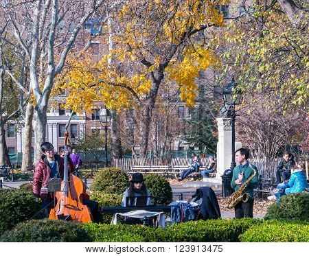 Manhattan New York - December 06 2015: Street musicians playing during lazy Sunday afternoon in Washington Square Park.