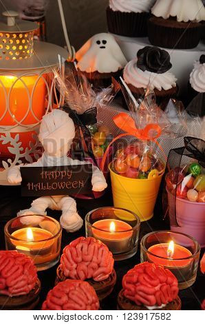 Cookies marzipan on a table with a variety of sweets in honor of Halloween