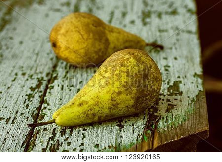 composition of two fresh pears on wooden background