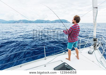 Man fishing in the sea from the boat