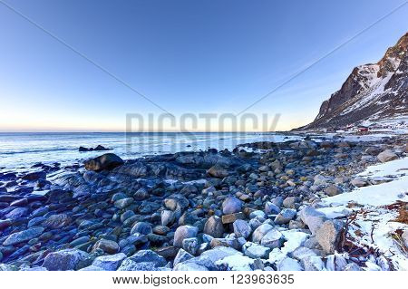 Vikten Beach in the Lofoten Islands Norway in the winter at sunset.