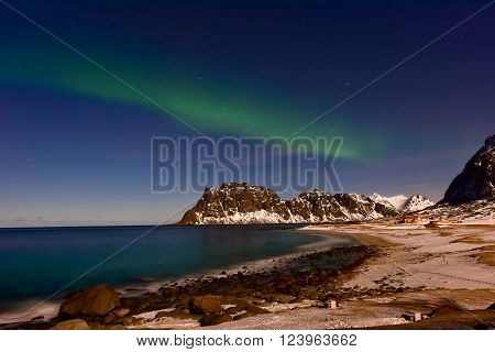 Northern lights over the sea at Utakleiv Beach Lofoten Islands Norway in the winter.