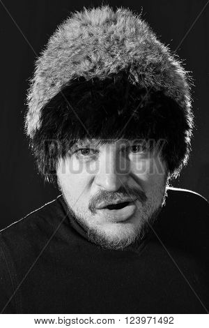 Portrait of middle-aged bearded man in fur hat