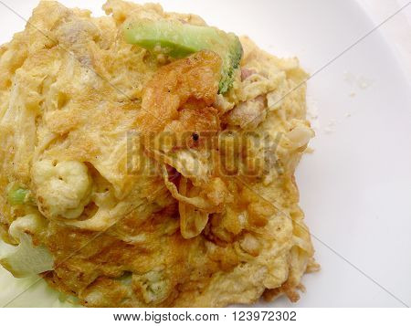 Thai-Style Omelet (Khai Jiao), Omelet with vegetables in white plate, It's popular traditional Thai style food
