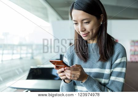 Woman use of cellphone in inddor cafe