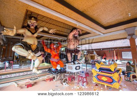 UBUD, INDONESIA - MAR 5, 2016: Unidentified local people during built Ogoh-ogoh are statues for the Ngrupuk parade, which takes place on the eve of Nyepi day. Nyepi is a public holiday in Indonesia.