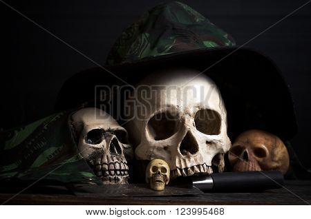 human skulls with hat and knif on dark background