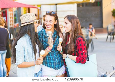 Three Happy Women Eating Ice Cream In The City