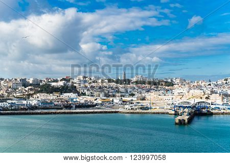 Ancient arabic city panorama view in Morocco Africa. View at Port of Tangier on a sunny day against blue cloudy sky, image for travel tourism concept blog business website