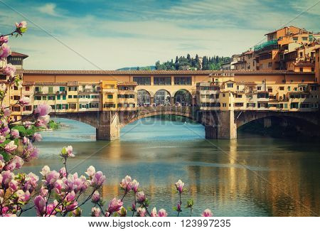famous bridge Ponte Vecchio over river Arno at spring day, Florence, Italy, retro toned