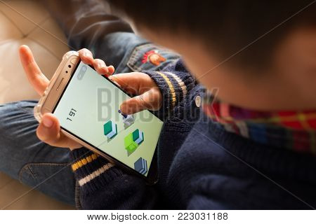 Zhongshan, China-January 22,2018: kid playing a mobile game inside Wechat own by Tencent.Tencent creates lots of popular mobile games & this Jumping game spreads out very fast in the new year of 2018.