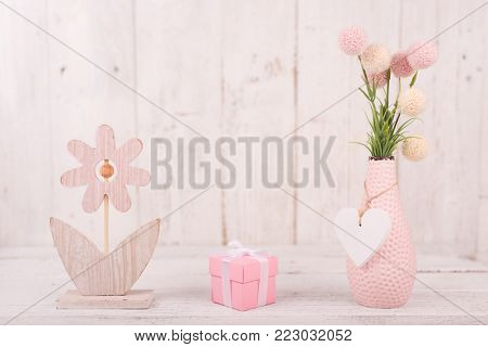 Flowers composition for Valentine's, Mother's or Women's Day. Pink flowers on old white wooden background. Still-life.