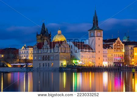 Beautifull night view of the Charles Bridge, the Old Town Bridge Tower, and the Old Water Tower, the Smetana Embankment and the Prague Beer Museum in Czech Republic New Year's Eve.