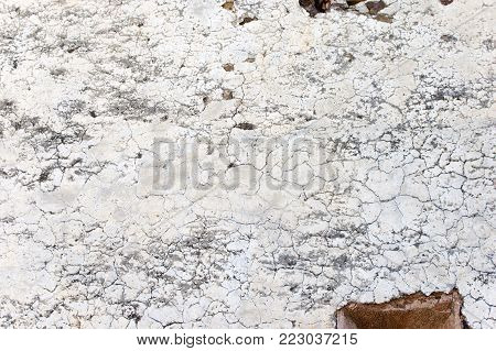 Closeup of a cracked old and weathered wall texture