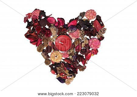Heart made of dried petals and flowers on a white background.