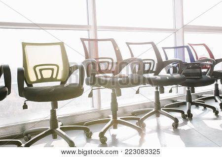 Luxury office furniture. Office chairs on window background.