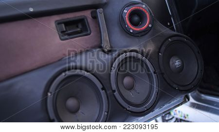 Car audio system close up honeycomb in front door panel, Car radio speaker. Music speakers in the doors of the car.