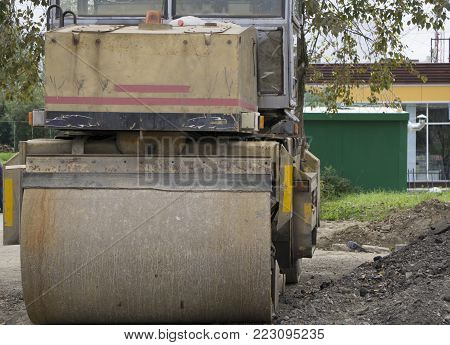 Workers operating asphalt paver machines and tippers during road construction and repairing works timelapse with tracking .