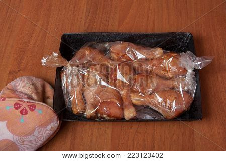 Chicken legs before baking in a baking sack