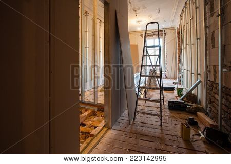 Interior of upgrade apartment with materials during on the remodeling, renovation, extension, restoration, reconstruction and construction. ( Making wall from gypsum plasterboard).