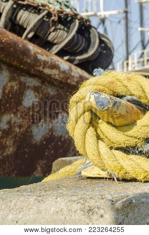 Cleated line to rusting fishing vessel in New Bedford harbor