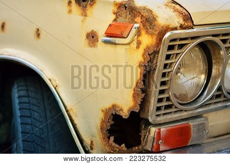 Old Soviet car rusted from the rain.