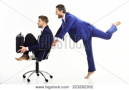 Business People Have Fun And Ride On Office Chair.