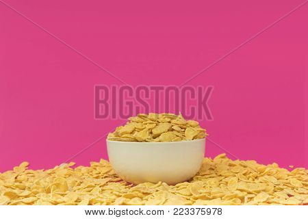 close-up view of white bowl with tasty crispy corn flakes isolated on pink