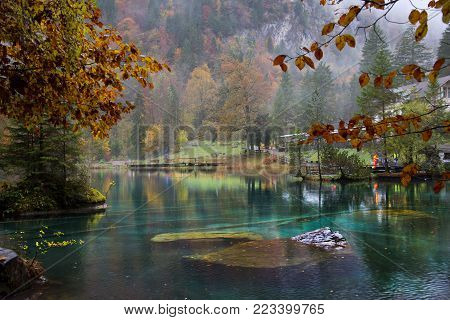 Beautiful crystal lake of Blausee with fog, Switzerland