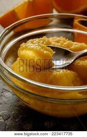 Fresh smoothie with oranges and two slices of orange. Just prepared food. Close up.