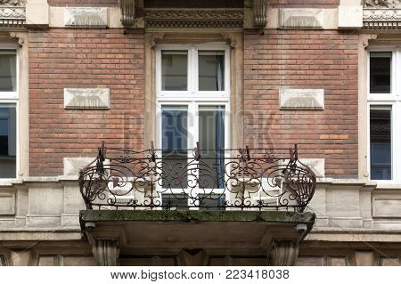The balcony on the facade of a brick house