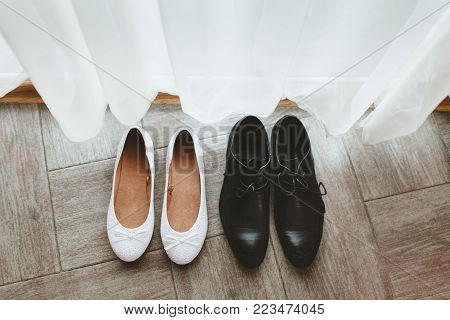 Wedding pair of shoes of the groom and the bride standing isolated