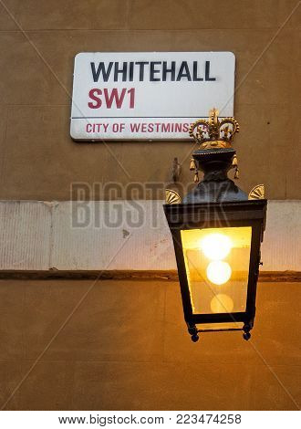 Whitehall Name Plaque with an old fashioned lit candle lantern.  The street is recognised as the centre of the Government of the United Kingdom, and is a busy throughfare between Trafalgar Square and Parliament Square.  London, UK, 2018