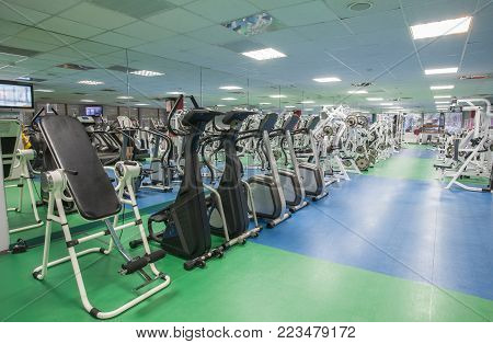 Sport gym interior with a treadmill equipment.