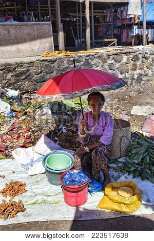 Maumere, Indonesia - May 9: An Unidentified Woman Holds An Umbrella At The Primary Market In Maumere